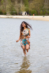 Obraz premium young indian woman running in the water