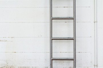 steel ladder on the dirty wall