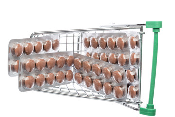 Naklejka premium Shop cart with brown pills blisters 