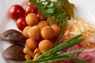 Close-up of cheese balls and pickled vegetables
