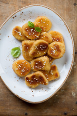 Sesame chicken nuggets in a glass plate, high angle view