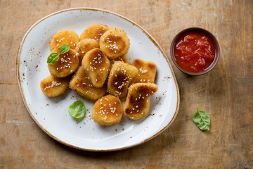 Glass plate with sesame chicken nuggets and dip sauce