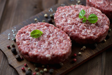 Close-up of raw beef cutlets with various spices