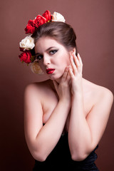 Naklejka premium Girl with flowers in head over brown background
