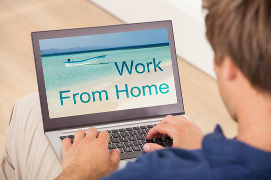 Man Working On Laptop At Home