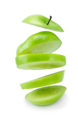 floating sliced green apple isolated on a white background.
