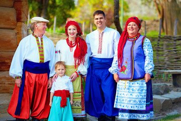 portrait of happy ukrainian family in traditional costumes