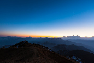 Fototapeta premium Twilight on Cattle Back Mountain with moon in the sky