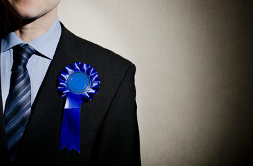 Election candidate with blue rosette. © John Gomez