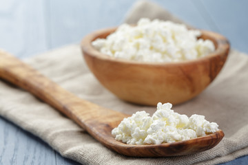 cottage cheese in wood bowl on blue wooden table