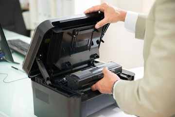 Businessman Fixing Cartridge In Photocopy Machine
