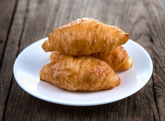 Croissant on wooden table