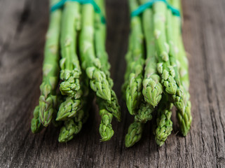 fresh green asparagus on wooden background