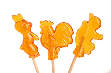 Sugar animals on sticks on white background
