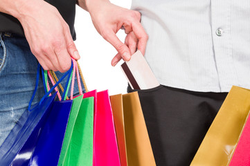 Shopping woman taking credit card from man's pocket