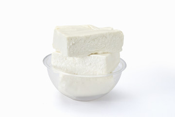 Fresh cheese from cow's milk in bowl on white background