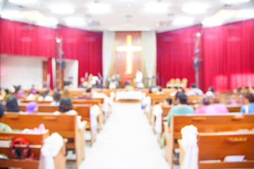 Blurred interior of church with many people