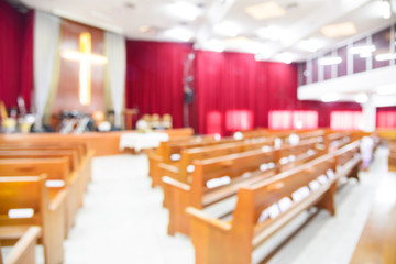 Blurred interior of empty church with empty pews