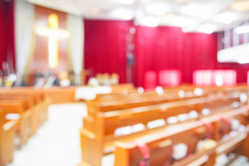 Blurred interior of empty church with empty pews