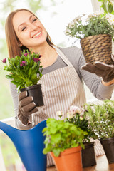 Caucasian young woman doing some gardening at home with her colo