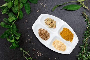 aromatic herbs and spices over slate sheet
