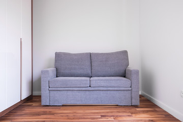 Gray sofa in empty room