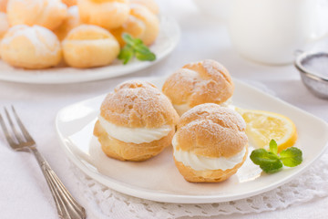 profiteroles with cream and powdered sugar