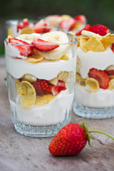 Cheese, strawberry, banana, cornflakes on the table. 