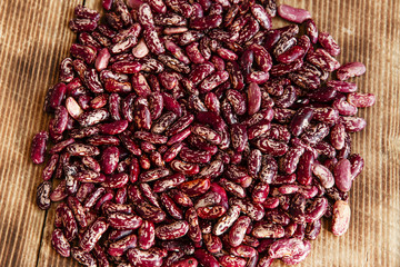 raw dried beans on a wooden surface