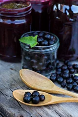 Foto op Plexiglas Вlack currant jam on the old table © julialototskaya