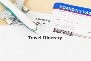 Travel itinerary with copy space, plane model, and boarding pass