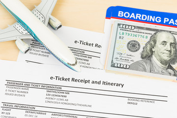 E-ticket with plane model, banknote, and boarding pass; these do