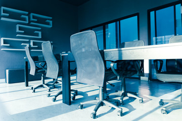 blue tone of  conference table and chairs with sun light in meet