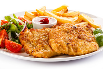 Fried pork chops, French fries and vegetables