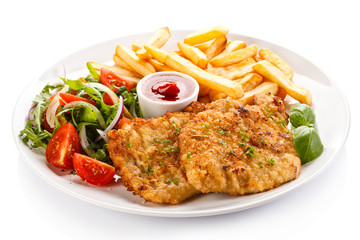 Fried pork chops, French fries and vegetables