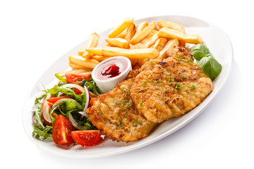 Fried pork chops, French fries and vegetables