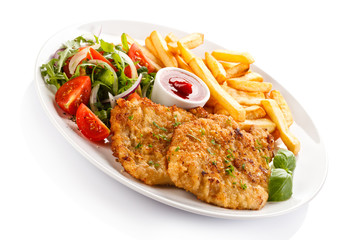 Fried pork chops, French fries and vegetables