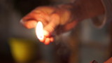 Woman Lights a Match.Close up of hands lighting a match.