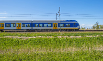 Naklejka premium Train driving through nature in spring