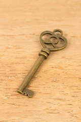 Antique key on wooden background