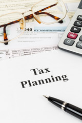 Tax planning wirh calculator and glasses taxation concept