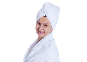 Aged good looking woman with white towel on her head