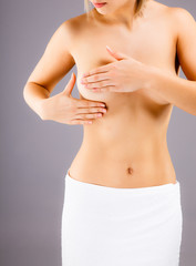 Woman examining her breast