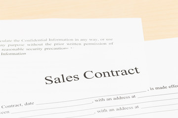 Sales contract on desk; document is mock-up