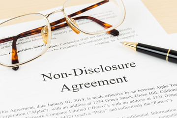 Non disclosure agreement document with pen and glasses; document