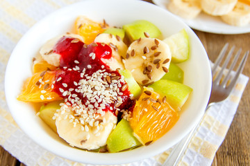 Fruit salad with cranberry sauce, sesame seeds