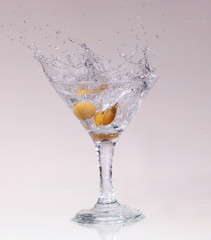 cocktail in a martini glass on a white background with fruit
