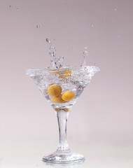 cocktail in a martini glass on a white background with fruit