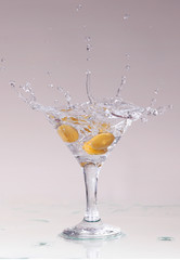 cocktail in a martini glass on a white background with fruit