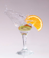 cocktail in a martini glass on a white background with fruit